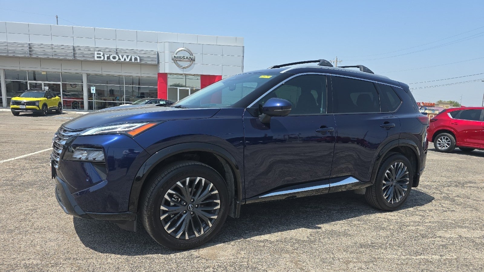 2026 Nissan Rogue Platinum in Deep Ocean Blue Pearl — front three-quarter view